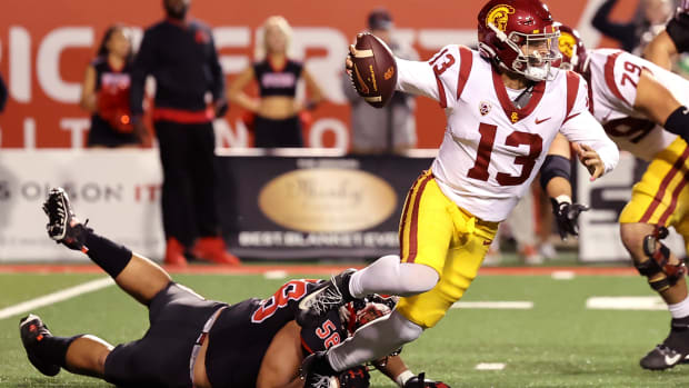 USC Trojans quarterback Caleb Williams (13) breaks a tackle by Utah Utes defensive tackle Junior Tafuna